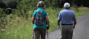 Two older adults walking in nature