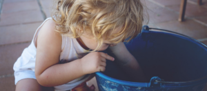 Water Play Free Program – Child Playing in a Bucket